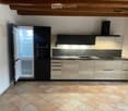 kitchen with wooden ceiling, tiled floor, open fridge, modern cabinets, granite countertop, double sink, oven, exhaust hood