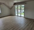 Unfurnished Room. Empty room with wooden floors, white walls, and large windows leading to a balcony.