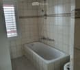 Bathroom. Bathroom with a bathtub, shower head, faucet, and toilet.