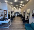 {"visible_features": [], "type": "Furnished Room", "objects": ["chairs", "mirrors", "desk", "couch", "clocks", "shelves", "bottles", "lamps", "cups", "bowls", "telephone", "clock", "cupboard", "tablet", "cupboard", "cupboard", "cupboard", "cupboard", "cup