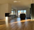 Unfurnished Room. Empty room with hardwood floors, white walls, and large windows. No furniture or equipment.