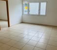 Unfurnished Room. Empty room with tiled floor, white walls, and large windows with blinds. No furniture or equipment present.