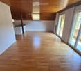 empty room, wooden floor, wooden ceiling, sliding glass doors, balcony, kitchen area