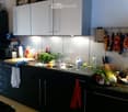 {"type": "Kitchen", "objects": ["sink", "faucet", "cutting board", "bowl", "cup", "bottle", "faucet", "oven", "microwave", "cupboard", "fridge", "oven", "fridge", "oven", "cupboard", "cupboard", "cupboard", "cupboard", "cupboard", "cupboard", "cupboard",