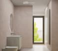 Modern bathroom with beige walls, white floor tiles, round mirror, white sink, and a white toilet.