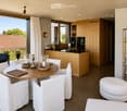 {"visible_features": ["View"], "type": "Furnished Room", "objects": ["round table", "chair", "stool", "kitchen island", "cupboard", "cupboard", "cupboard", "cupboard", "cupboard", "cupboard", "cupboard", "cupboard", "cupboard", "cupboard", "cupboard", "cu
