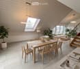 Open-plan living and dining area with light wood paneling, marble flooring, and modern furniture including a dining table, chairs, sofa, coffee table, and decorative items.