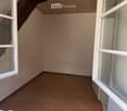 empty room, wooden floor, white walls, two windows, wooden beam