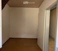 empty room, wooden floor, white walls, two windows, open door