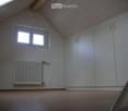white walls, wooden ceiling, white shelves, radiator, floor
