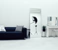 A modern, minimalist room with a dark blue sofa, a large mirror, a vanity with a chair, a small table, and a potted plant. A camera on a tripod is positioned near the mirror.