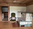 fireplace, wooden chair, remote, tiled flooring, wooden walls, wooden ceiling