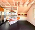 {"visible_features": [],    "type": "Room",    "description": "Modern kitchen, dark tiles, island countertop, central stove, extractor hood, fridge, dishwasher, white cabinets, ceiling beams",    "localized_descriptions":        {        "EN": "Moder