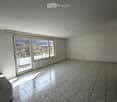 empty room, white walls, tiled floor, large glass door, balcony, view of trees and mountains