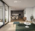 Modern living and dining area with light wood flooring, large windows, grey sofa, white coffee table, green rug, dining table with chairs, kitchen area with cabinets and appliances.