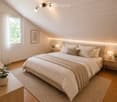Cozy attic bedroom with wooden walls and ceiling, large bed with white bedding, nightstands with lamps, and a potted plant on a side table.