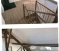 Spacious hallway with wooden flooring, white walls, and large windows allowing natural light. Features a wooden staircase with metal railings leading to an upper level.