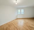 room, wooden floor, white walls, ceiling light, window, outlet