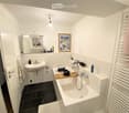 Modern bathroom with white tiles, a sink, a bathtub, a mirror, and a framed picture on the wall. The space includes a towel rack and various bathroom accessories.