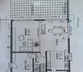 Floor plan showing a layout with labeled rooms including Wohnen (living area), Essen (dining area), Küche (kitchen), Arbeitszimmer (office), Vorplatz (entrance), and Sitzplatz (seating area).