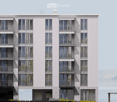 Modern multi-story residential building with large windows and balconies, featuring a clean, contemporary design.