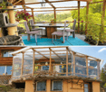 A spacious, open-air balcony with a wooden frame, glass panels, and a scenic view of green hills. Features a dining table with chairs, a cat tree, and potted plants.