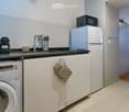{"visible_features": [], "type": "Kitchen", "objects": ["refrigerator", "microwave", "sink", "faucet", "oven", "washing machine", "oven", "oven", "oven", "oven", "oven", "oven", "oven", "oven", "oven", "oven", "oven", "oven", "oven", "oven", "oven", "oven