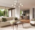 Modern living room with beige sofa, glass center table, and wooden coffee table. It also features a kitchen area and floor-to-ceiling windows