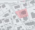 Floor plan showing multiple plots and buildings with numbered designations and labeled streets.