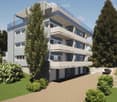 Modern multi-story apartment building with balconies, surrounded by greenery and a paved driveway with a parking spot.
