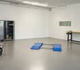 Workshop or garage space with a metal cabinet, workbench, air compressor, and work platform.