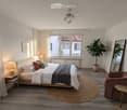 Modern bedroom with a large bed, nightstand, armchair, round rug, and large window with white curtains. Features a potted plant and decorative artwork on the walls.