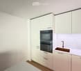 Modern kitchen with white cabinets, double oven, sink, and faucet.