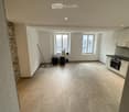 Empty room with tiled floor, white walls, and large windows. No furniture or equipment present.
