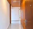 Bright, clean hallway with wooden ceiling and walls, white walls, and a single light fixture.