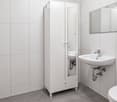 Modern bathroom with white tiles, a sink, a mirror, a cabinet, and a toilet.