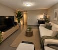 Modern living room with a white sofa, coffee table, TV stand, desk, and plants.