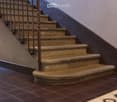 Stone steps, metal handrail, tiled wall