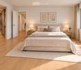 Modern bedroom with a large bed, nightstands, lamps, and a view of the landscape through a large window.