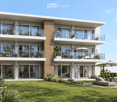 Modern two-story house with large glass windows, balconies, and outdoor seating area with lounge chairs and umbrellas.