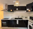 {"type": "Kitchen", "objects": ["oven", "dishwasher", "washing machine", "sink", "faucet", "oven hood", "cabinet", "light fixture", "towel", "oven", "microwave", "refrigerator", "oven", "oven", "oven", "oven", "oven", "oven", "oven", "oven", "oven", "oven