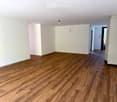 empty room, wooden flooring, white walls, small ceiling light