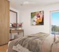 Modern bedroom with a large bed, nightstand, mirror, and a colorful painting on the wall. The room features a large window with a view and a sleek wooden wardrobe.