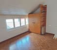 empty room, wooden floor, white walls, window, tall wooden cabinet, white handrail