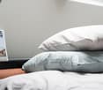 Unmade bed with two pillows and bed sheet on top