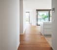 white walls, wooden floor, glass doors, balcony