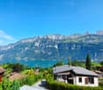 Houses in rural area, lake, mountain, green vegetation