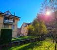 House: brick, balcony, green lawn, trees, mountain view