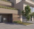 modern building, Aurelia text, 3 garages, entrance doors, small tree in front, planted area