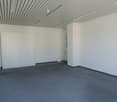 Empty room, carpeted floor, white walls, white cabinet, power outlet